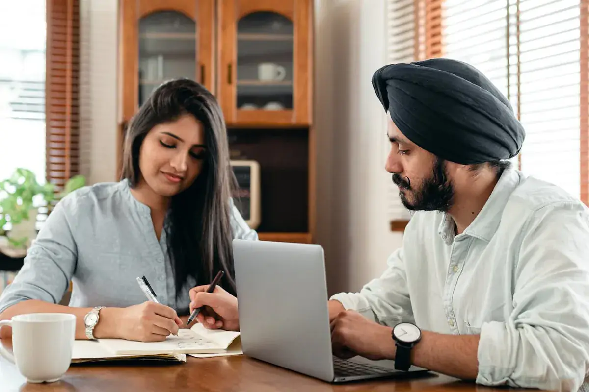 Student and tutor in an interactive online tutoring session via laptop with notes and study materials
